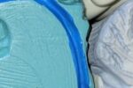 A colorful anatomical model of a human brain, featuring different sections in blue, green, yellow, and gray, representing various brain parts.
