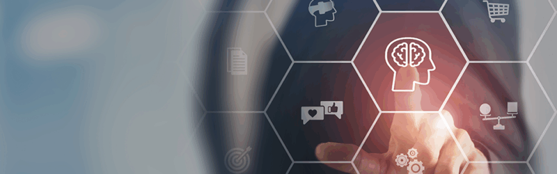 A person interacting with a virtual interface displaying various icons, including a brain symbol, representing ideas or innovation in technology.